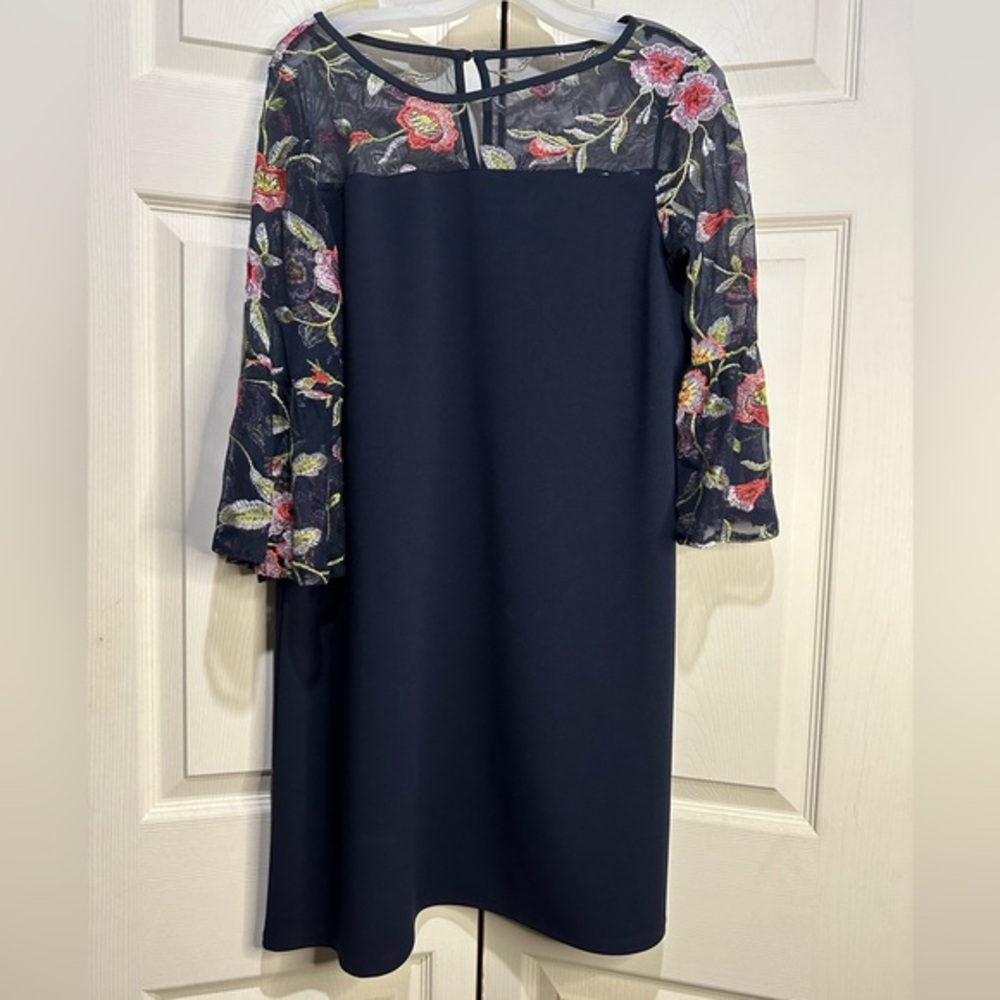 AGB navy dress with sheer floral details at neck and sleeves. Size 10.